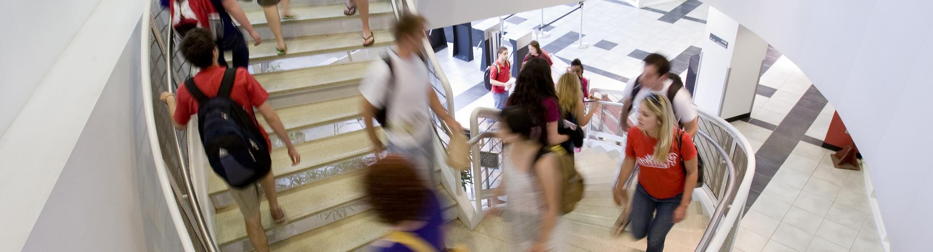 students walking to class up a spiral staircase